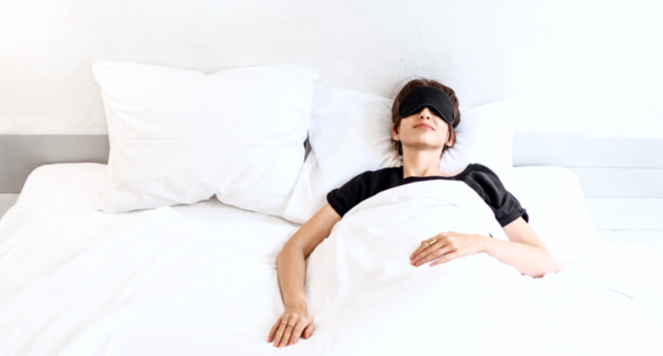 woman with eye mask in bed